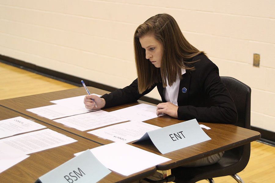 Senior Emma Tibbetts reads through her scenario to prep for the interview.