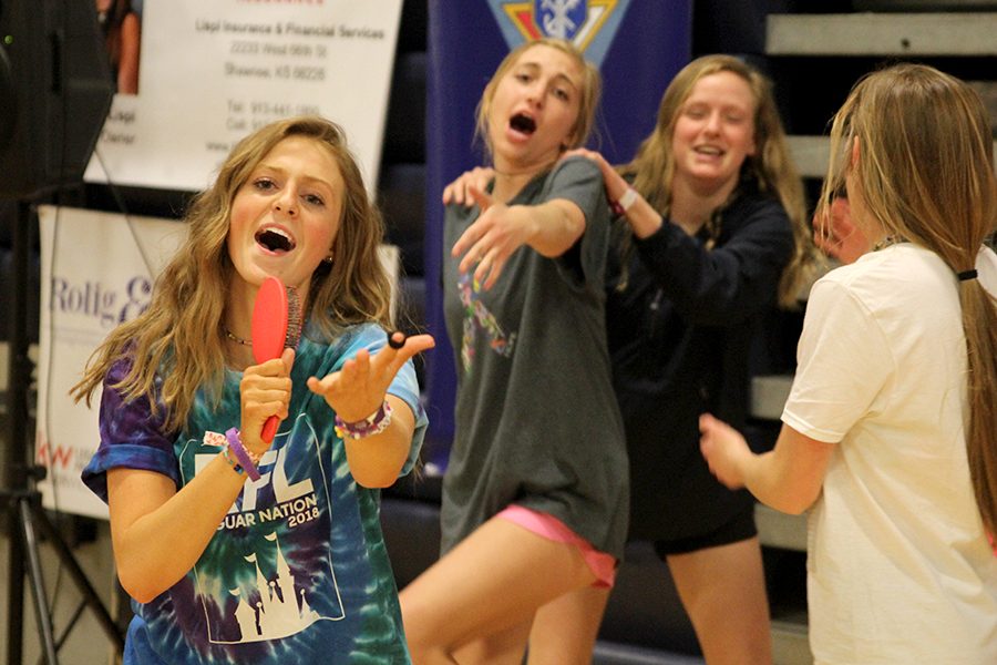 Junior Annie Bogart sings into a hairbrush during the dance party.