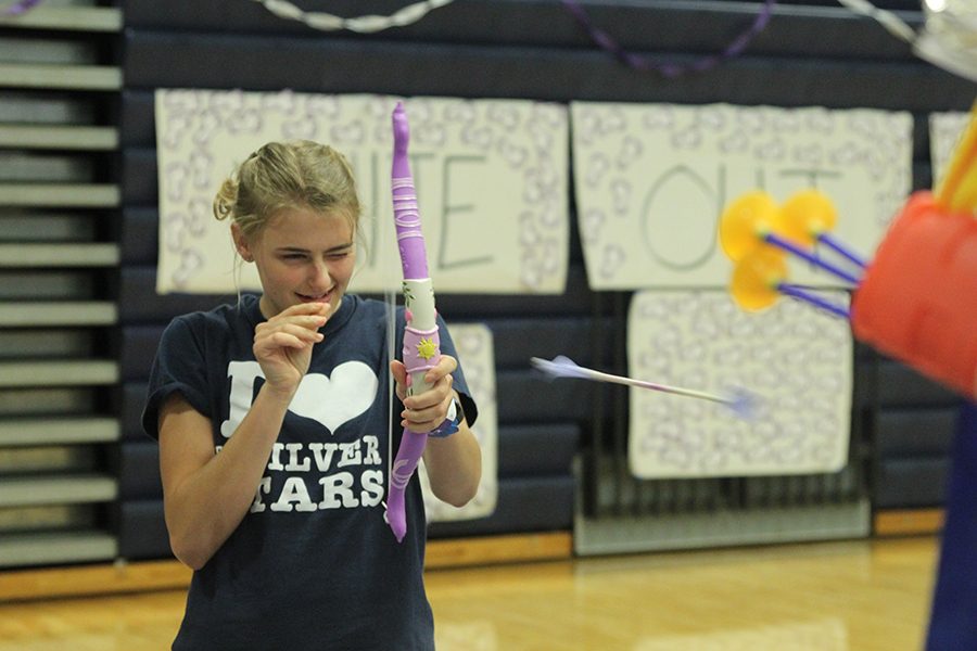 Senior Bella Hadden shoots an arrow during an on-site fundraiser.