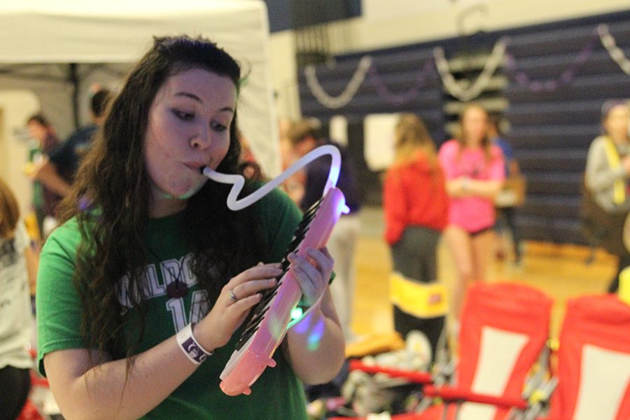 Senior Lauryn Hurley plays a melodica as part of her on-site fundraiser.