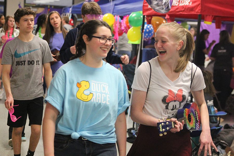 Junior Ally Appl plays the ukulele while walking laps during Relay for Life. The event took place on Friday, March 23 and raised a total of $81,454.98 for cancer research.