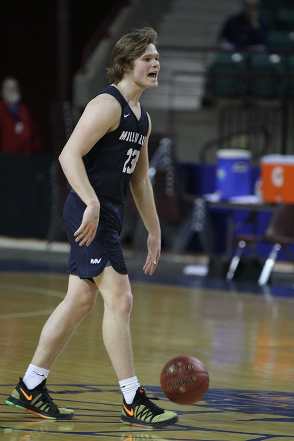 Senior Cooper Kaifes dribbles the ball beyond the three point line.