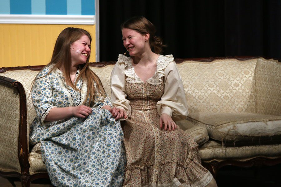 Kitty, played by sophomore Lauren O'Neal, laughs with her sister Lydia, played by junior Lindsay O'Neal. 