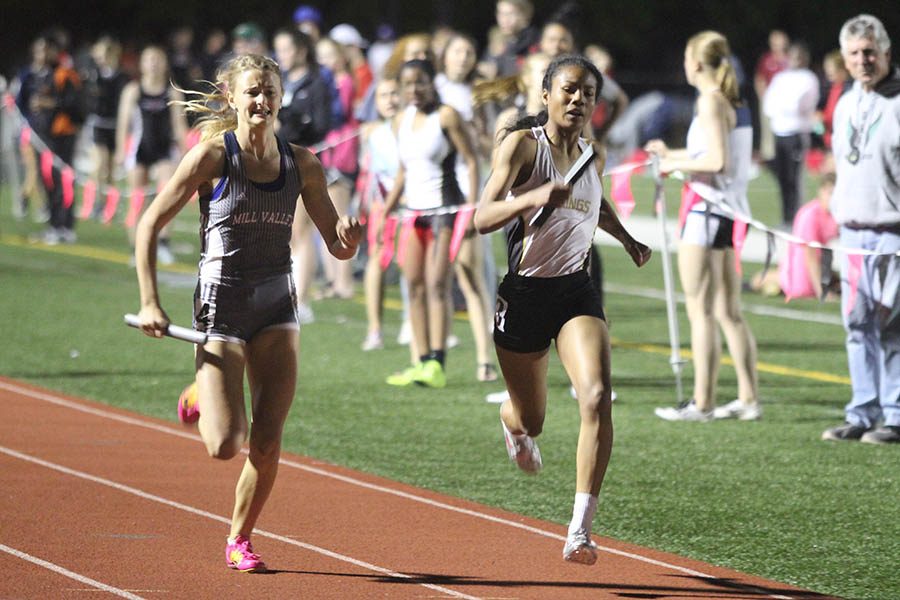 As she nears the finish line in the 4x400, senior Bella Hadden attempts to pass another runner.