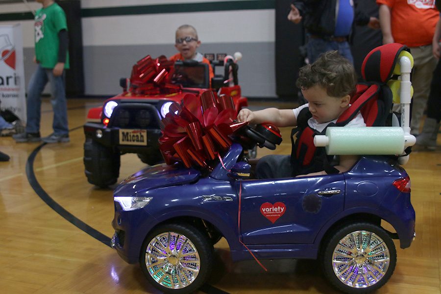 The two boys that the team made the cars for, Micah and Jeremiah, play with their adapted vehicles.