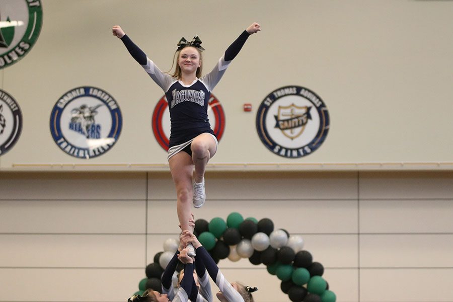 Performing in her individual stunt routine, junior Trinity Ouellette smiles at the judges.