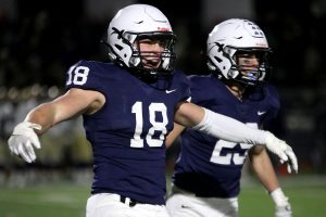 With his arms out to the side, junior linebacker Broc Worcester looks to his teammates on the sideline to celebrate his tackle Friday, Nov. 19. 