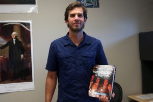 Holding a psychology textbook, social studies and psychology teacher Reece Petty is eager to get back into teaching,  Wednesday, August 31. “I am looking forward to getting back into teaching social studies and getting in the flow of teaching psychology again” Petty said. “Adding civics on to that, it’ll be a lot of fun.” 