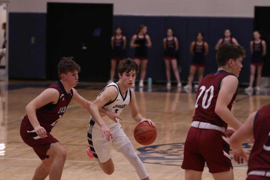 In hopes of making a point for the team, senior Brooks Jahnke dribbles the ball to get closer to the net.