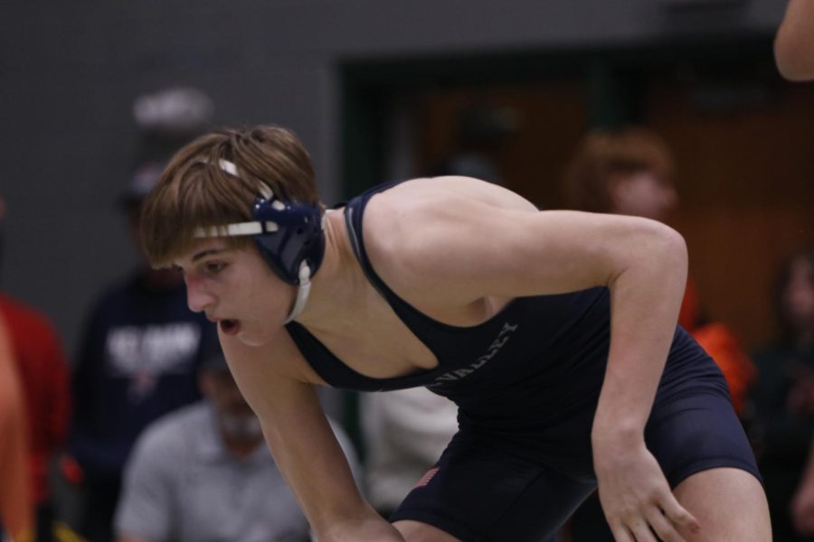 Taking a breath, junior Colin McAlister waits for his opponent to make a move during his match.