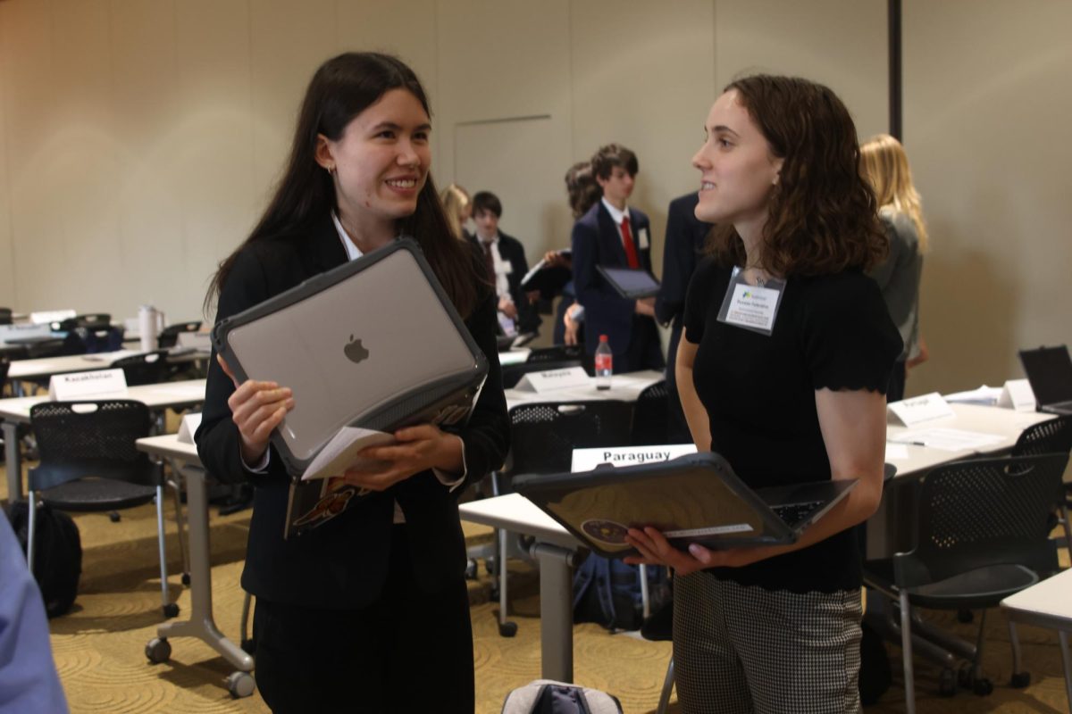 Representing Poland in the Commission on Population and Development, junior Sophie Hsu negotiates a resolution with a delegate representing Russia from De Soto.