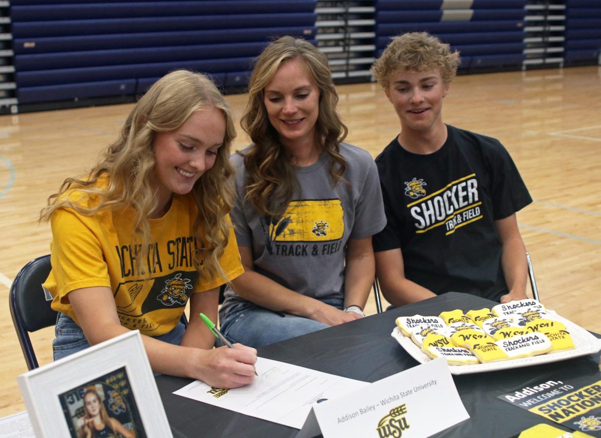 With her mom and brother sophomore Adam Bailey, signee senior Addison Bailey signs at Wichita State University for track and field. 