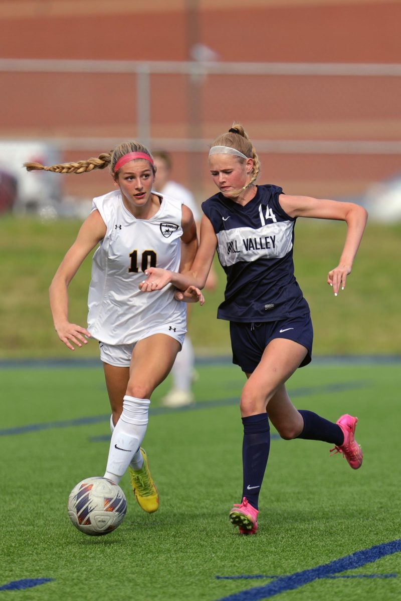 With her arms out, junior Calista Marx tries to get past another player.