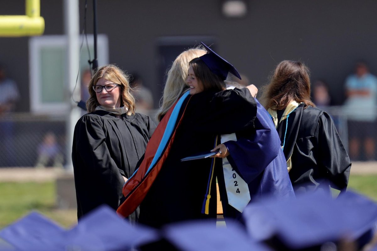 After receiving her diploma, graduate Chloe Clayton hugs Principle Dr. Gail Holder.