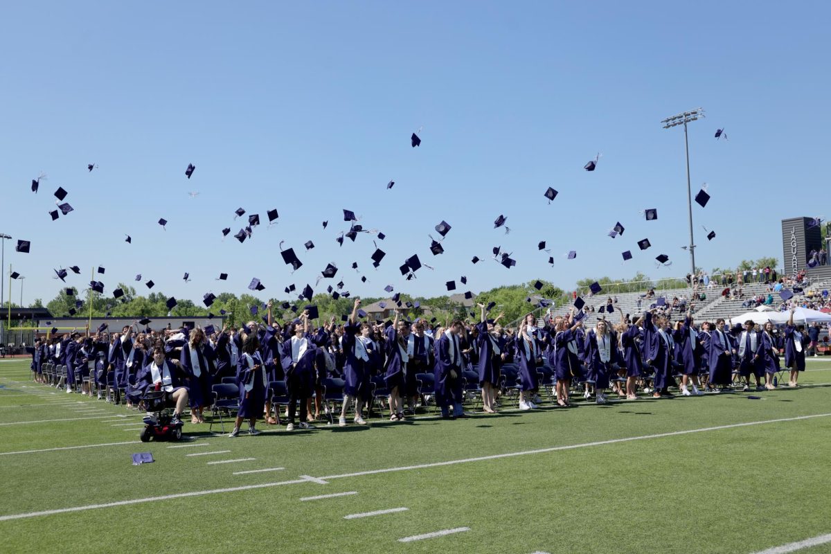 At the conclusion of the ceremony, graduates toss their caps in the air.
