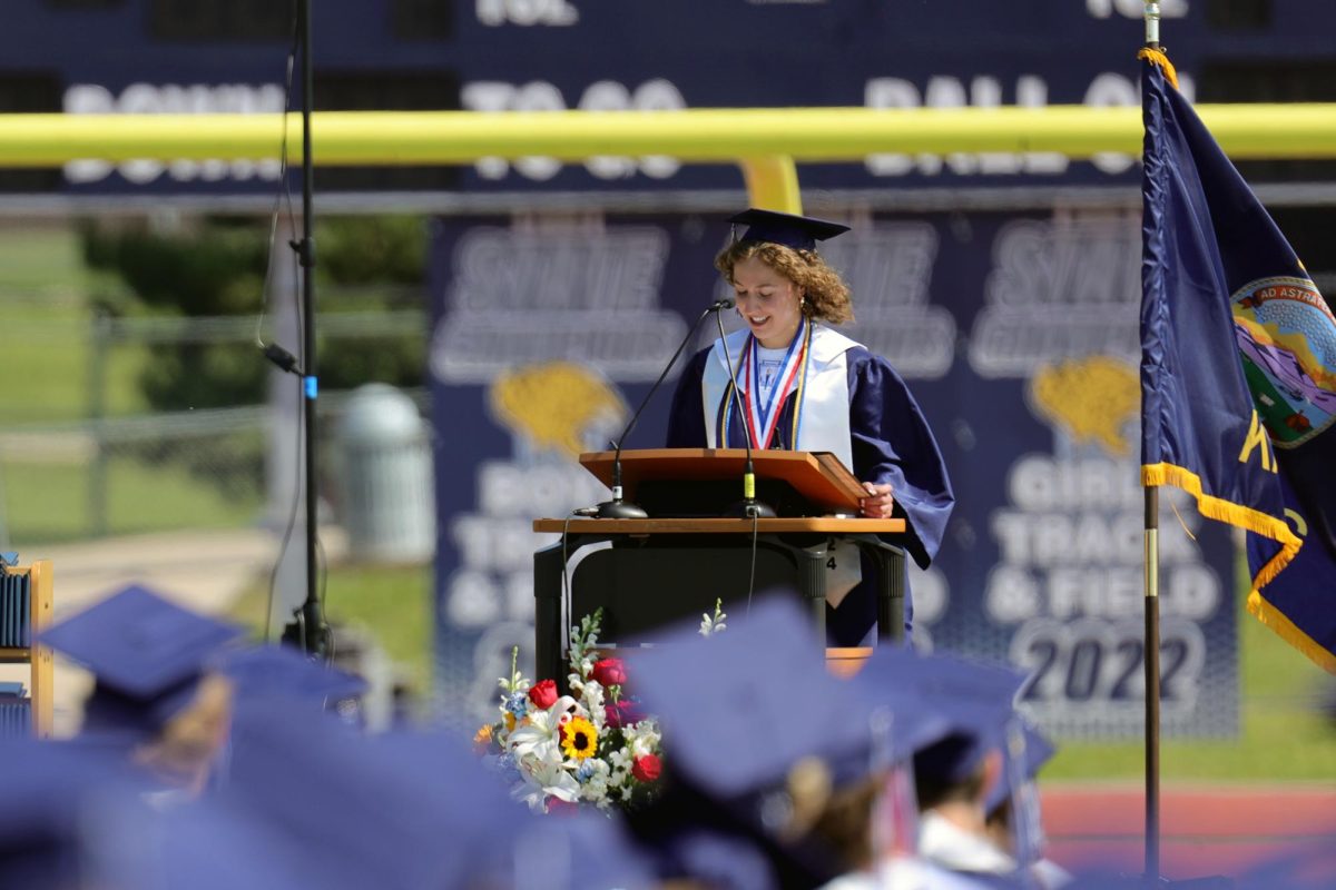 Smiling, graduate Sarah Anderson gives her valedictorian speech.