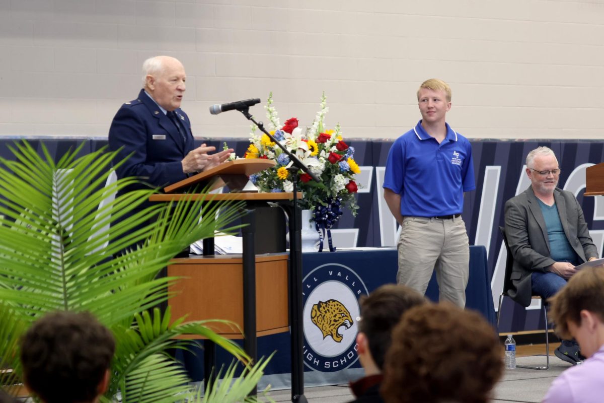 Lt. Colonel Gregory Shuey presents senior Robert Hickman with a Certificate of Appointment into the Air Force Academy.