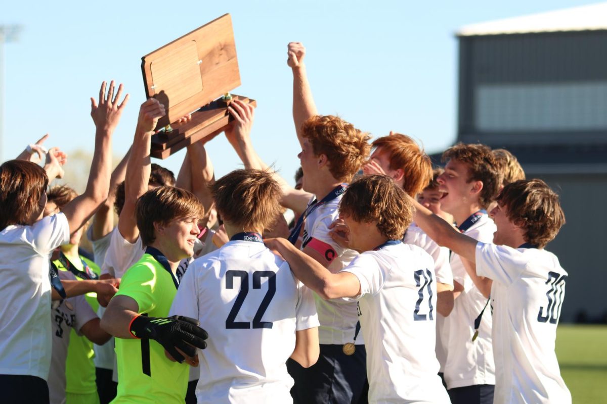 Holding their trophy overhead, the Mill Valley boys soccer team celebrates winning the state championship title Saturday, Nov. 5 2023 against Olathe West. 