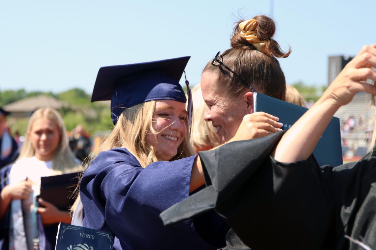 Hugging and smiling, senior Molly Morgan and teacher Mrs. Huang, share a bittersweet moment 