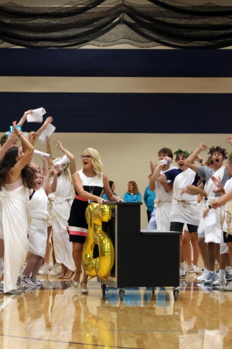 During the pep assembly, principal Dr. Gail Holder gets introduced through cheers.