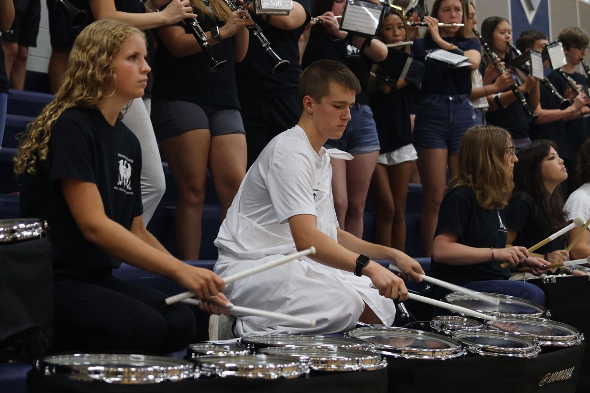 Beginning the pep assembly, juniors Abby Haney and Carson Schmidtlein play the drums.