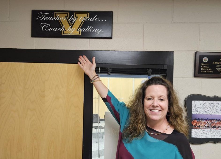 New choir teacher Laura VanLeeuwen poses with a sign given to her by past students. 