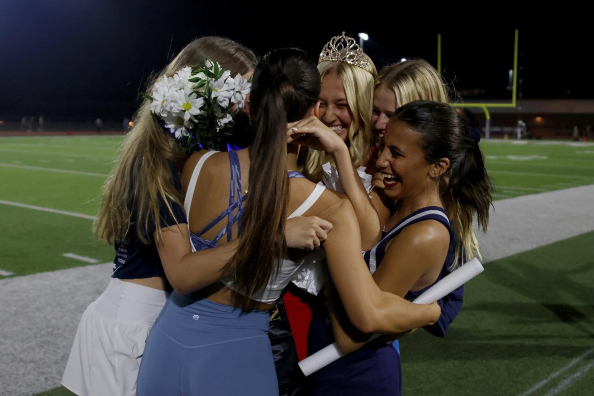 After coronation, Homecoming Queen Maggie Wieland hugs seniors Jada Winfrey, Calista Marx and Isabel Cherrito.
