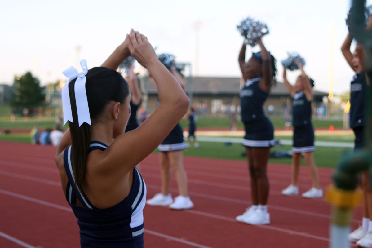 Senior Emerson Jones leads her Junior Jag cheerleaders in a cheer. 