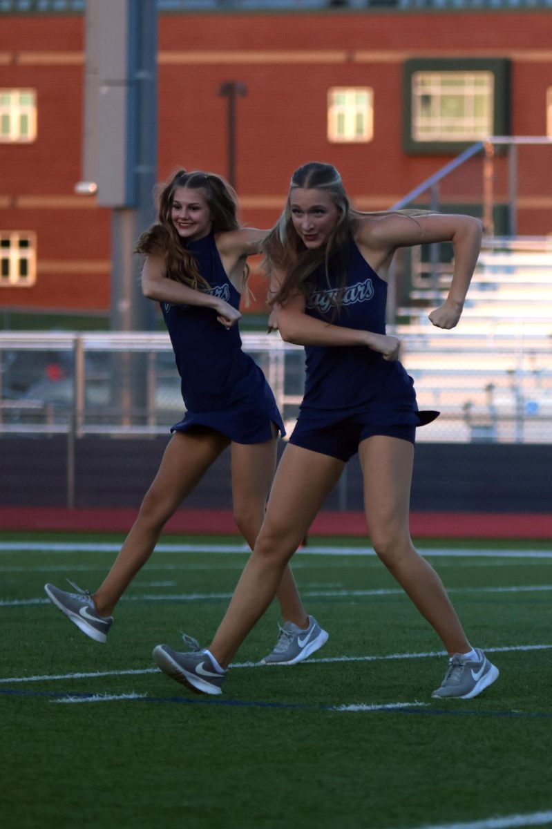 Senior Ashley Ayers and junior Ella jones dance in sync during their routine.