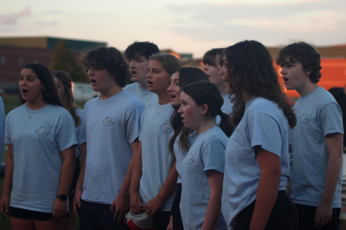 Choir performs the national anthem before the high school scrimmage. 