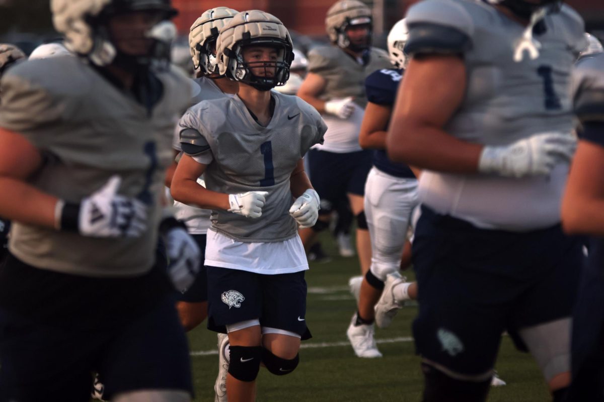 High school football player warms up before the scrimmage. 