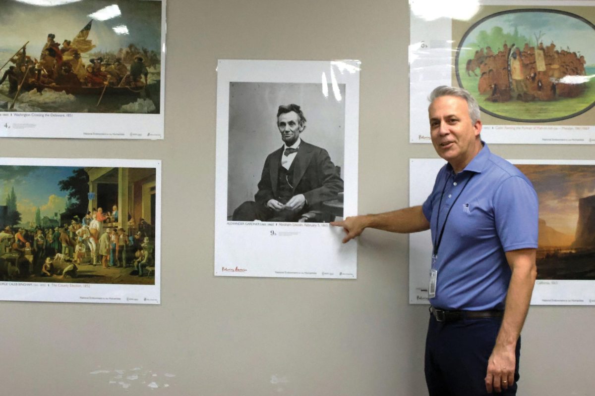 History teacher Jeff Wieland decorates his room with learning tools for his students including his poster of Abraham Lincoln. 