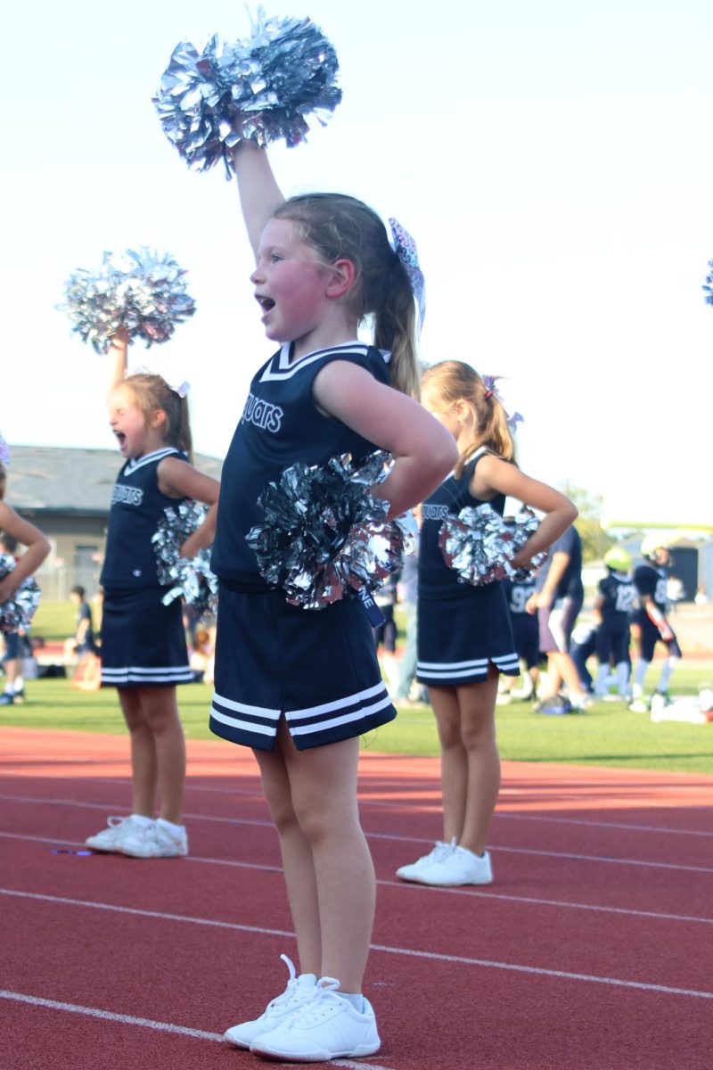 Waving their poms to the crowd, Junior Jag cheerleaders lead the chant. 