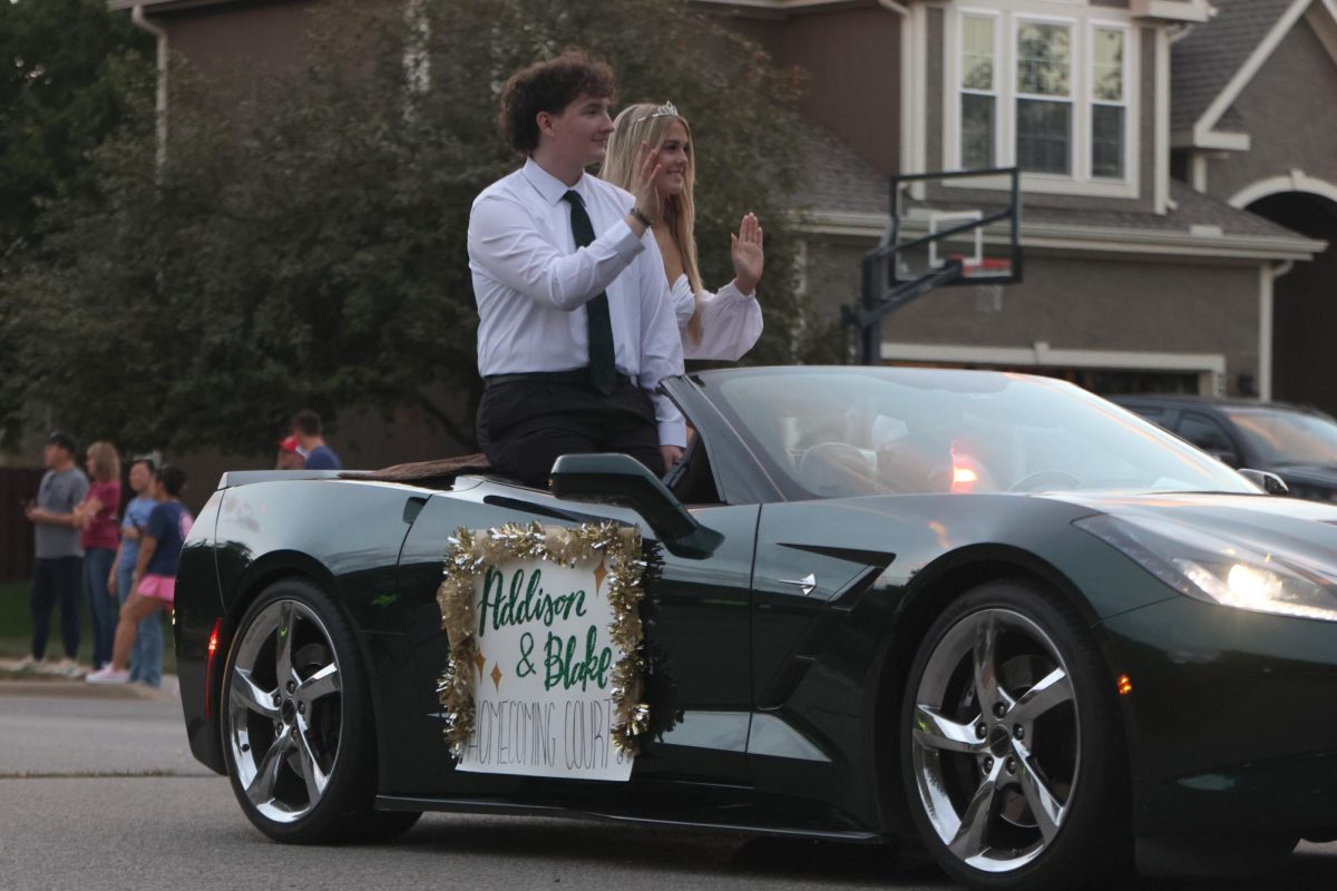 Homecoming court candidates, Blake Gray and Addison Long wave to the parade spectators. 