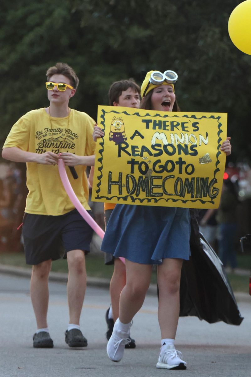 Showing school spirit, freshmen Jack Musil and Isabel Mohr walk with the freshman float. 
