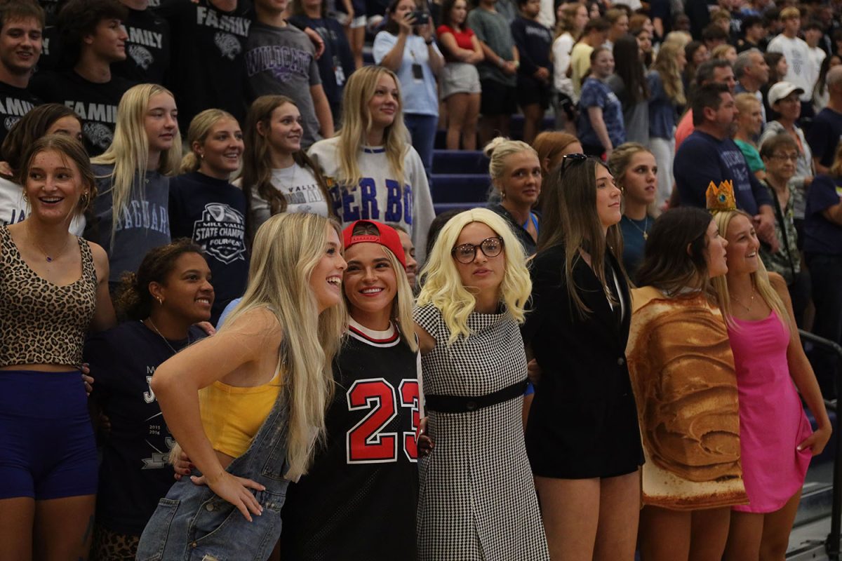 Swaying together, seniors Addison Long, Logan Miller and Marissa Hoelting listen along to the Alma Mater.