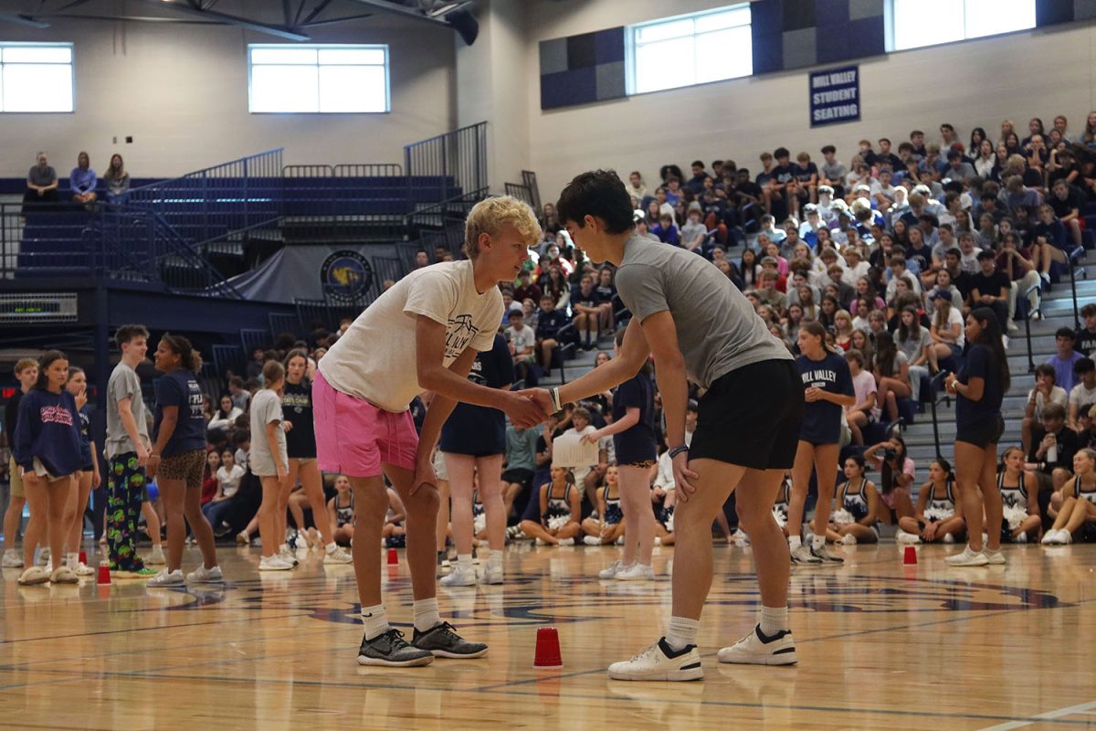 Shaking hands, sophomore Kai Campbell an senior Noah Pham get ready to start round one of "head, shoulders, knees, and cup."