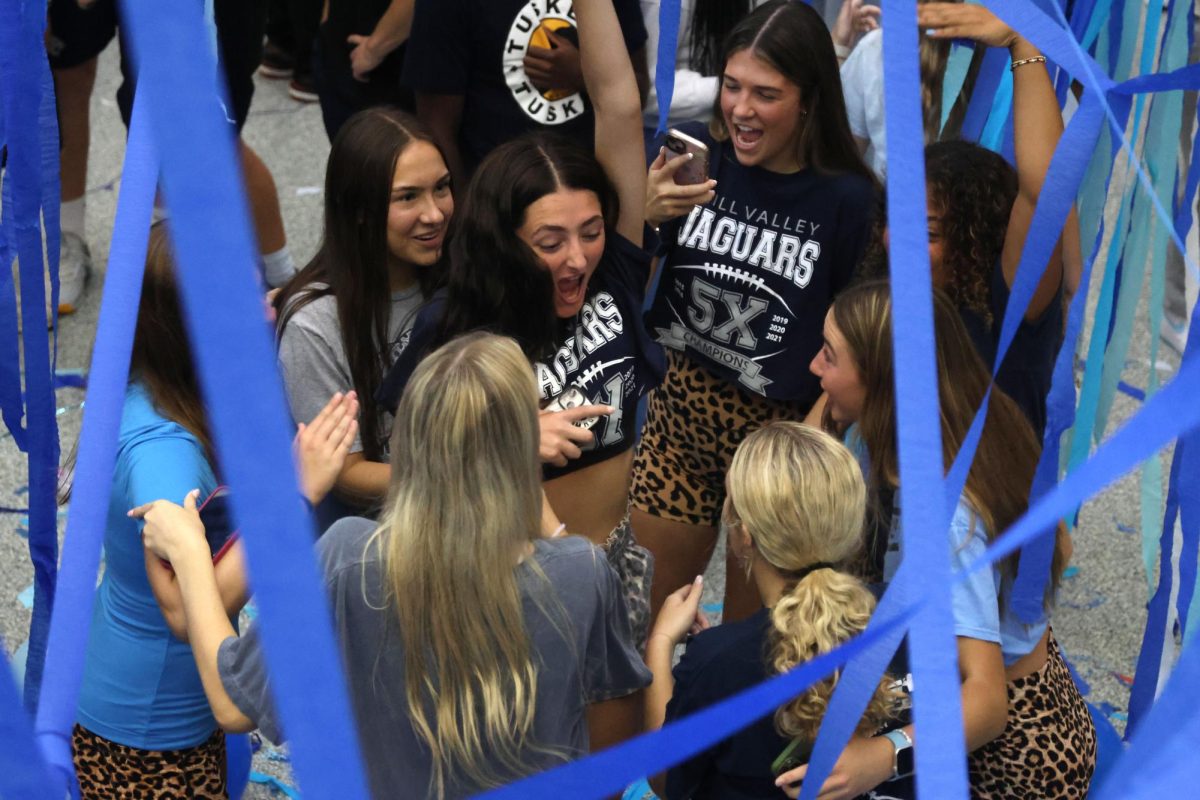 Surrounded by friends, senior Lily Friedman dances in the middle of the circle. 
