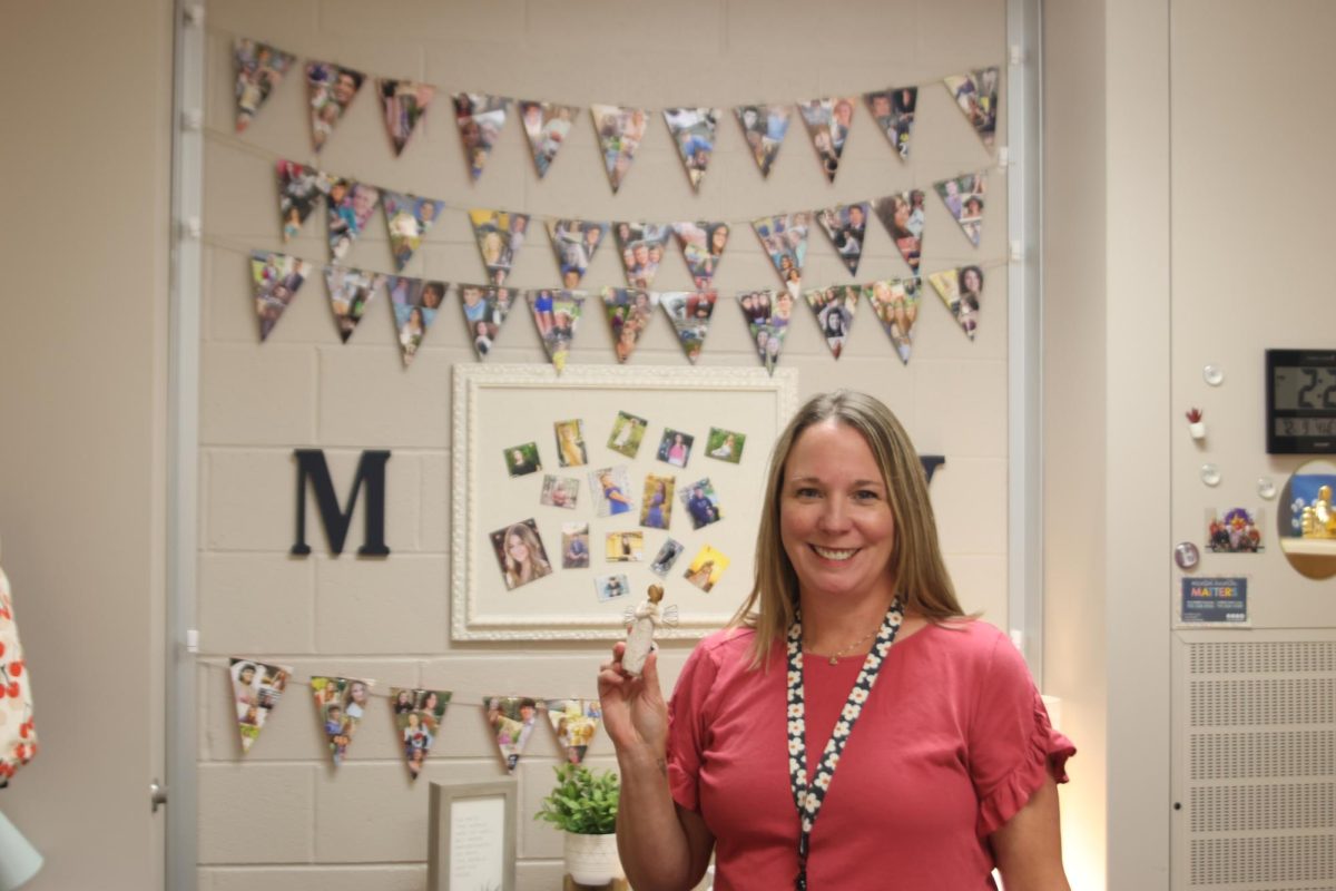 Counselor Erin Hayes holds an angle that english teacher Dorthy Swafford gifted her to represent her mom that passed away. 