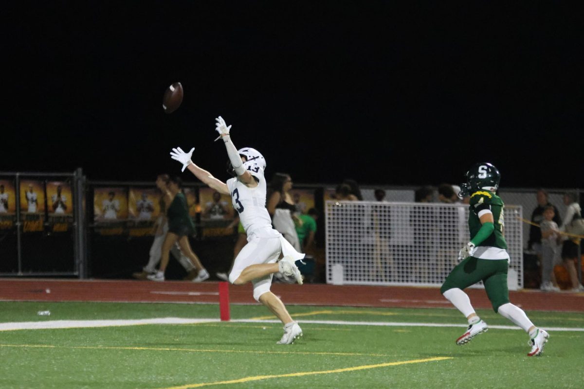 With the ball just out of reach, Junior Bryce Shorten tries to catch it.