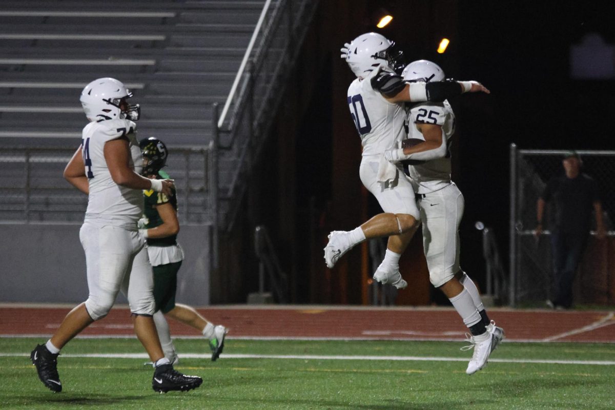 Junior Reggie Reece celebrates a touchdown with his teammates.