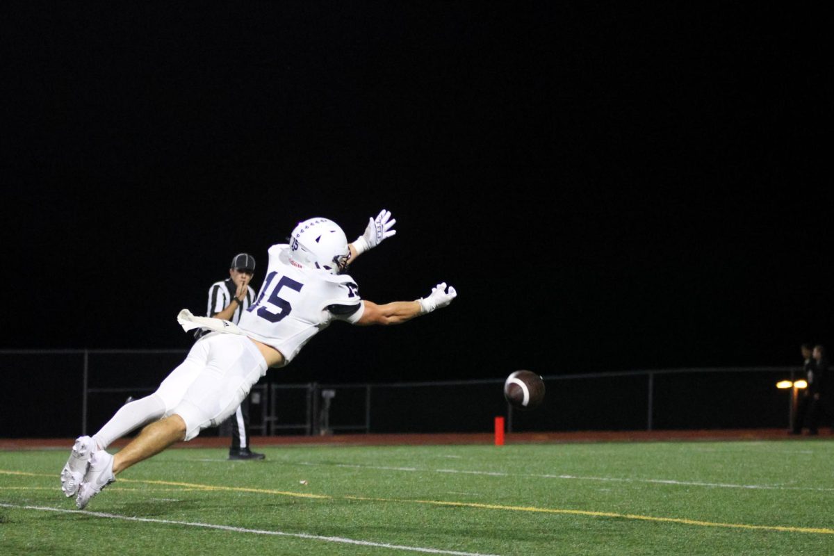 Just short of the ball, senior Andy Watts dives to catch it.