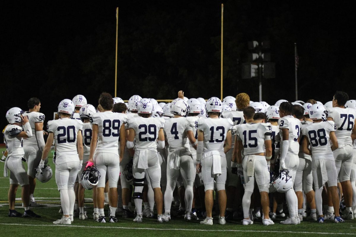 Before 3rd quarter starts, the team huddles up.