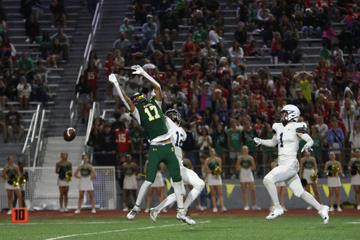 Junior Blake Jay blocks his opponent from catching the ball.