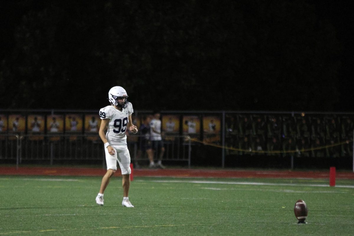 Warming up, senior Aiden Standley, gets ready for kickoff.