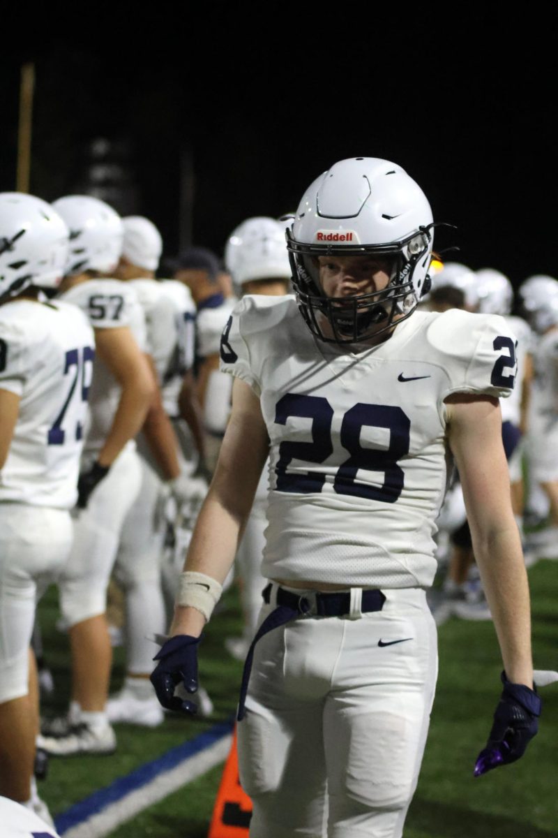 After a play, Junior Tyler Laningham heads over to his teammates.