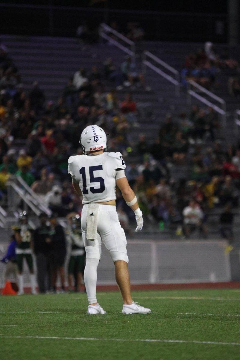 Standing tall, Senior Andy Watts looks over at his opponent.