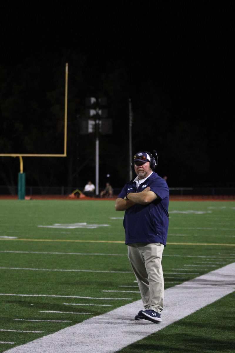 Arms crossed, Coach Wurtz looks at the camera.