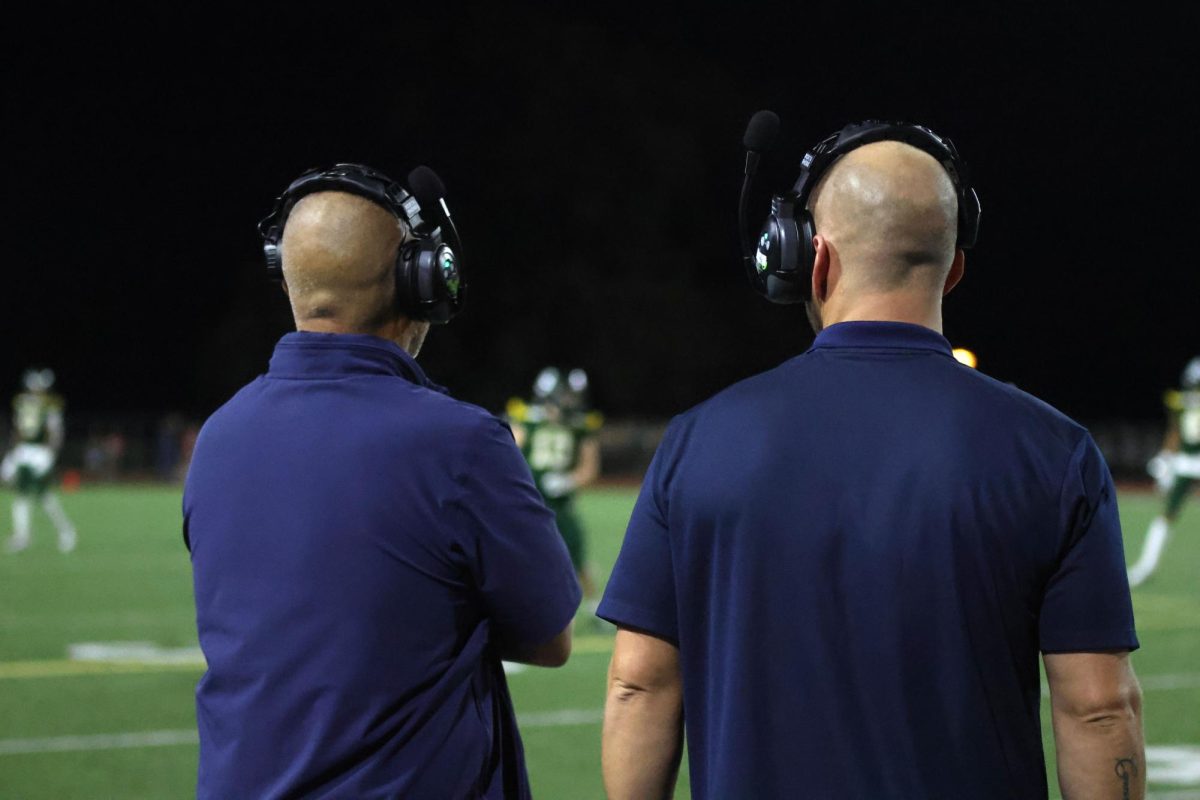 Coach Applebee and Coach Ress watch the game closely.