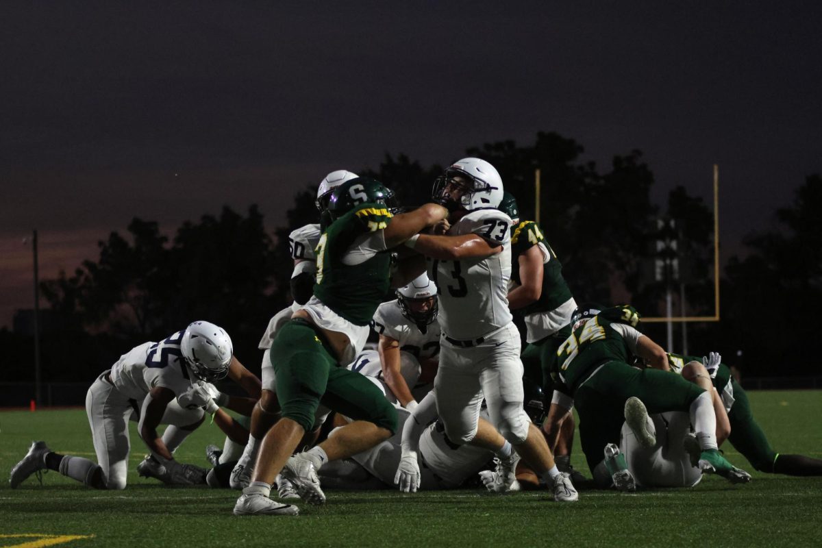 Junior Bryce Shorten blocks the other team from the ball.